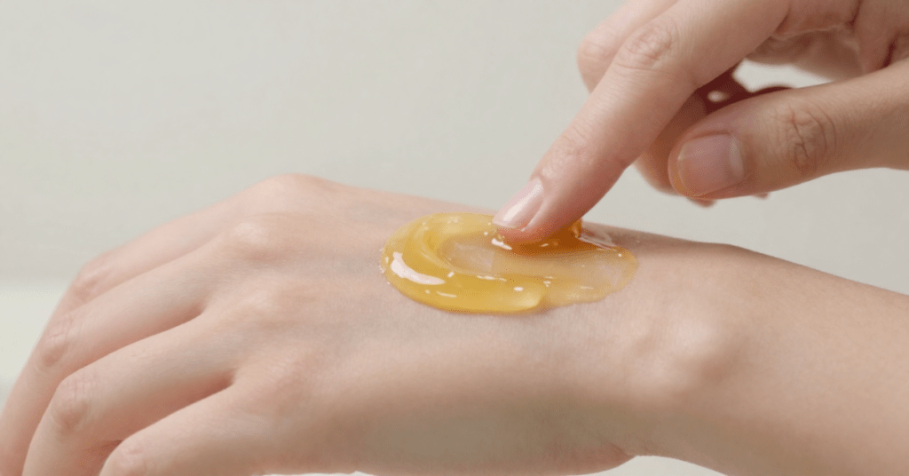 Applying the paste to the skin.